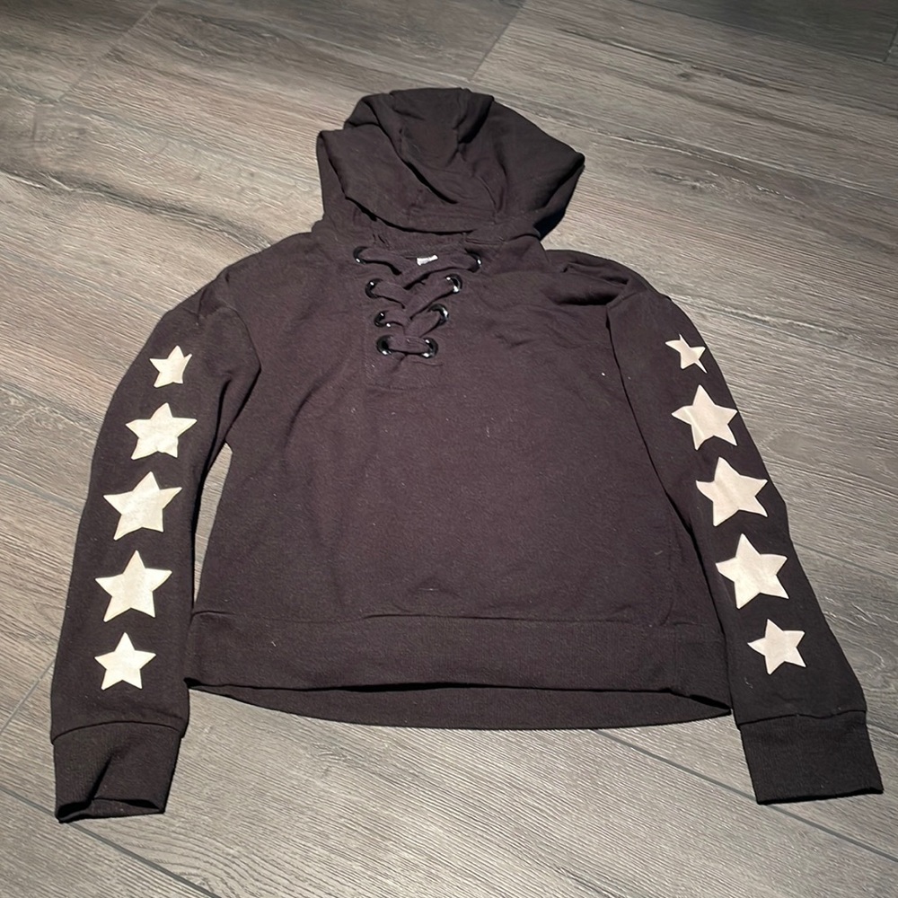 Girls black tie up sweatshirt with white stars on sleeves. Size small (7/8)